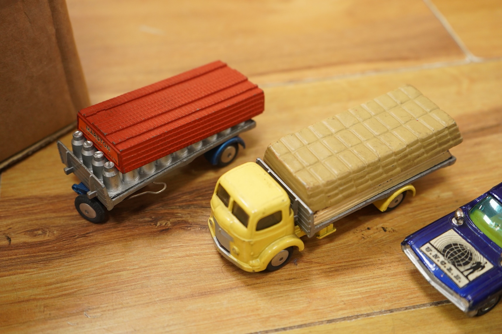 A collection of forty Corgi Toys and fourteen Matchbox Series diecast vehicles, including; The Man From Uncle Oldsmobile, a James Bond Aston Martin DB5 in gold, a Commer 5-ton truck with trailer and a selection of loads,